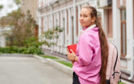 Student girl holding books in her hands