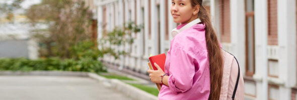 Student girl holding books in her hands